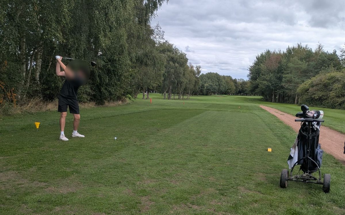 A player driving off a tee
